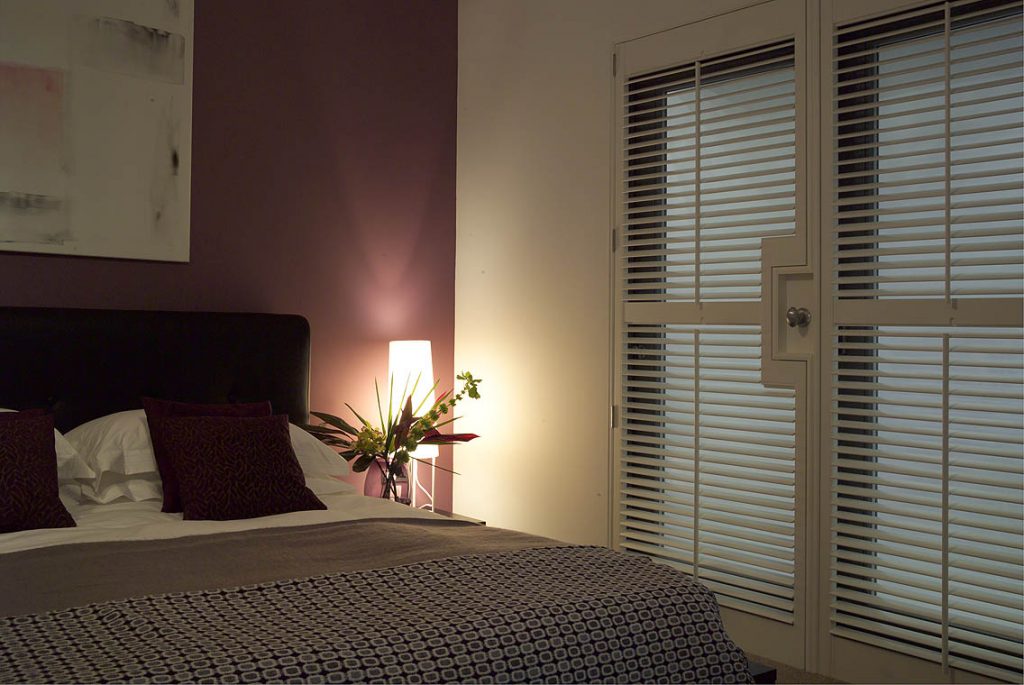 White window shutters in bedroom