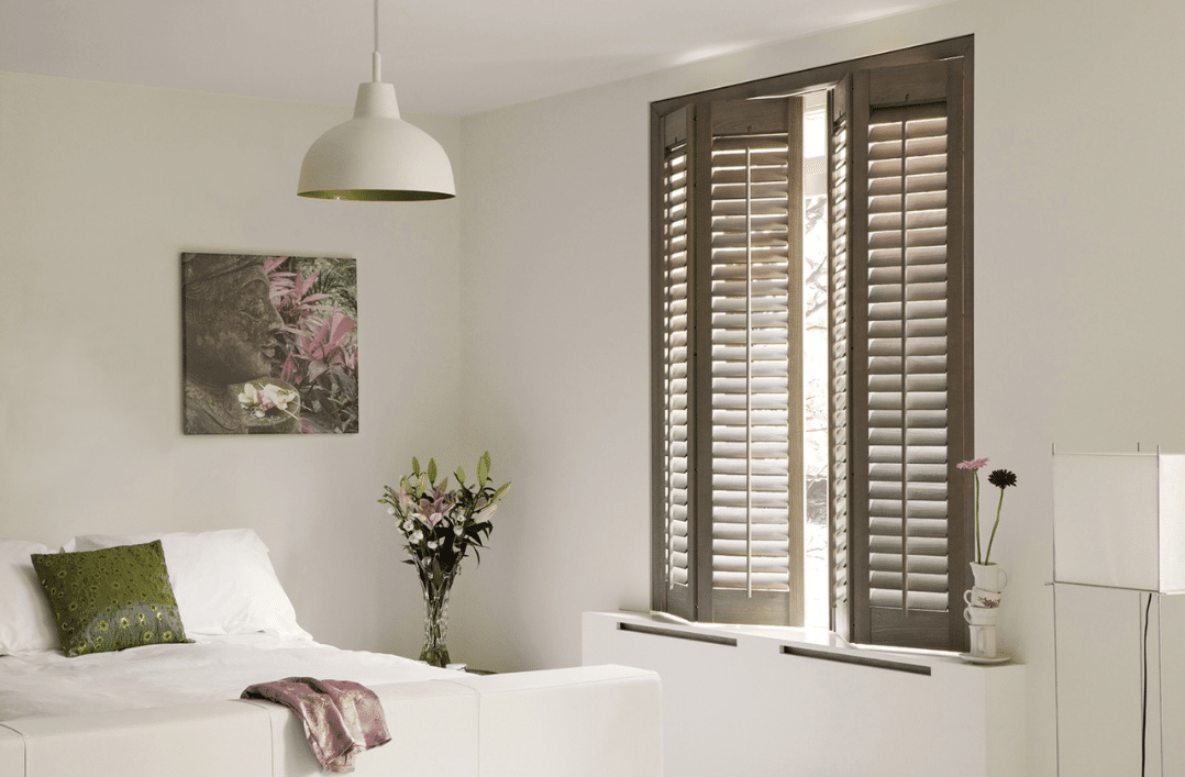 bedroom with full height shutters in Falmouth