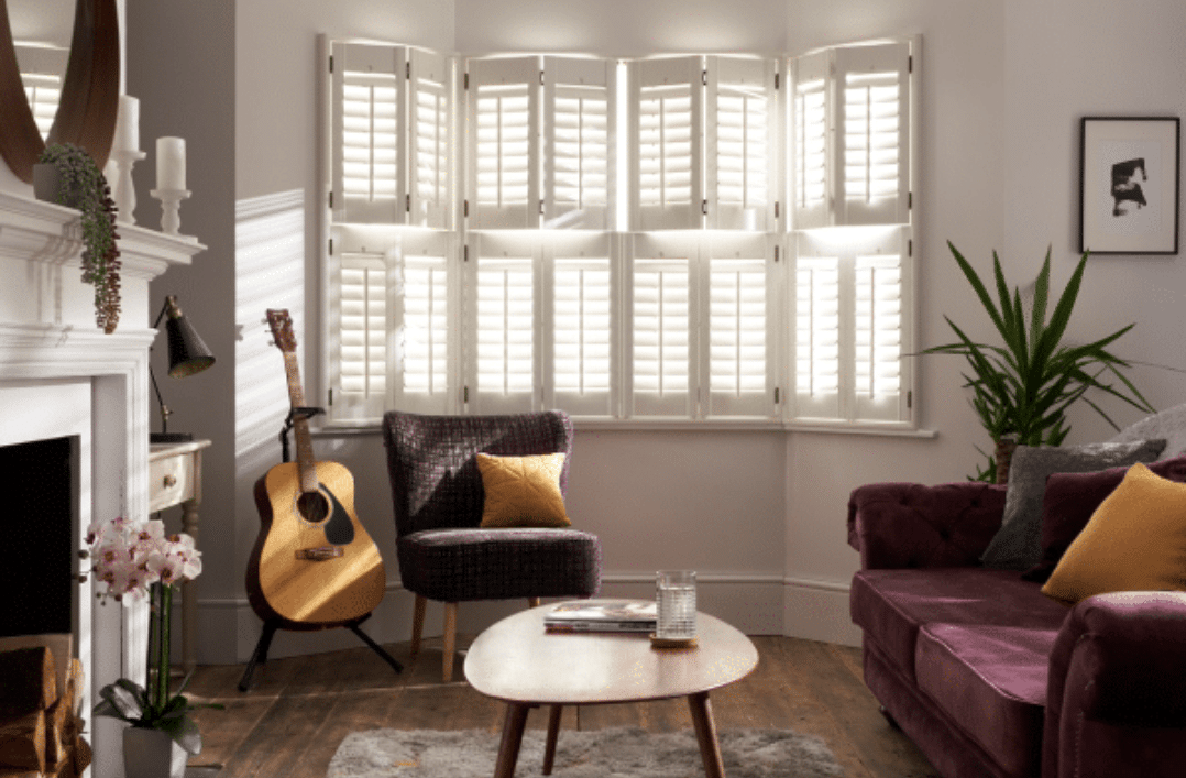 Living room with tier on tier shutters in Falmouth